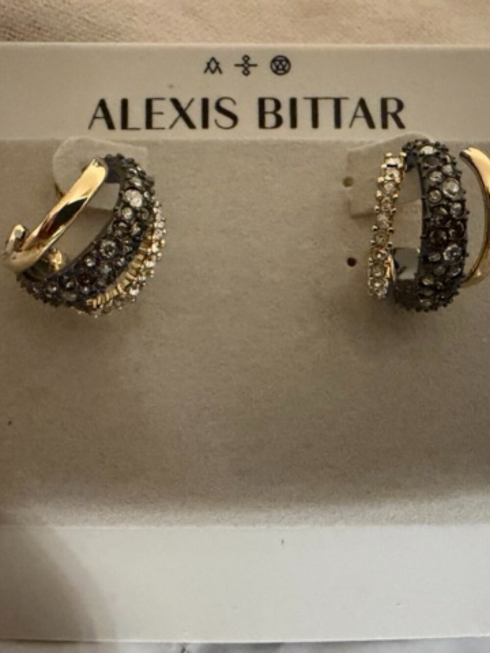 These Alexis Bittar earrings feature a multi-layered design.